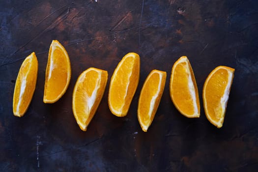 Orange slices on a dark background. Concept