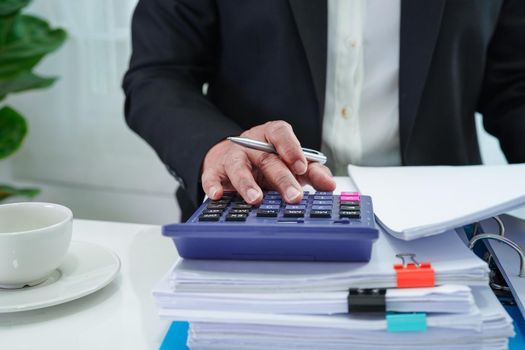 Businessman working and prepare paperwork report data to analysis information in file binder at office.
