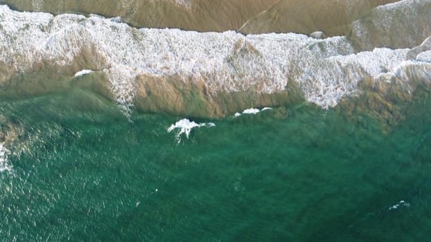 Aerial view of an emerald green sea and big foaming waves. Indian Ocean. Dikwella beach. Sri Lanka. High quality photo