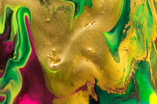 Gold dust spots on liquid fluorescent paints background