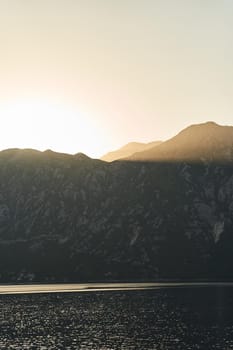 View of the sunset in Boko-Kotor Bay in Montenegro. Silhouettes of mountains. High quality photo