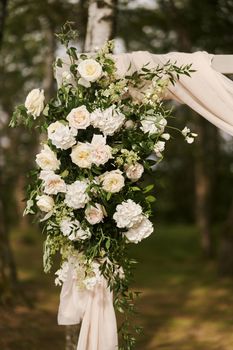 Wedding decorations. Flowers on the wedding arch. Decoration of a wedding celebration. High-quality photo