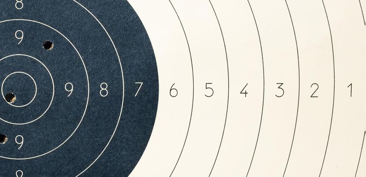 Target with numbers for shooting at a shooting range. A round target with a marked bull's-eye for shooting practice on the shooting range. Target with bullet holes