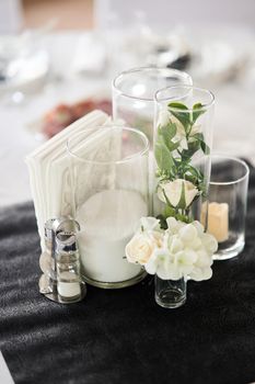 Decoration of wedding tables. Plates with the numbers of the tables at the wedding. Flower arrangements. High-quality photo