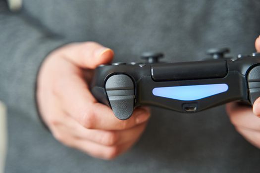 Gamer girl. Joystick for game console. The girl plays in the console. Close-up. Girl holding a joystick for a game console