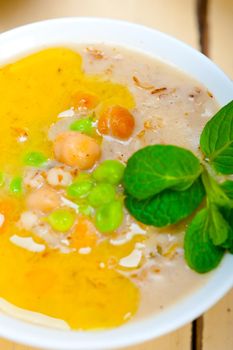 Hearty Middle Eastern Chickpea and Barley Soup with mint leaves on top