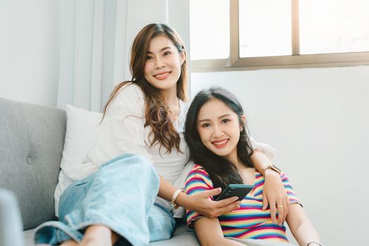 lgbtq, lgbt concept, homosexuality, portrait of two asian women enjoying together and showing love for each other while using smartphone mobile to take selfies.