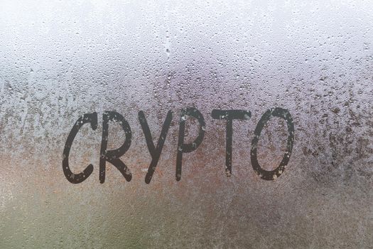 crypto handwritten on wet glass of night window.