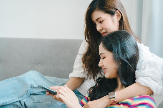 lgbtq, lgbt concept, homosexuality, portrait of two asian women enjoying together and showing love for each other while using smartphone mobile to take selfies.