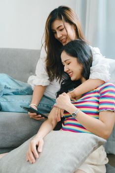 lgbtq, lgbt concept, homosexuality, portrait of two asian women enjoying together and showing love for each other while using smartphone mobile to take selfies.