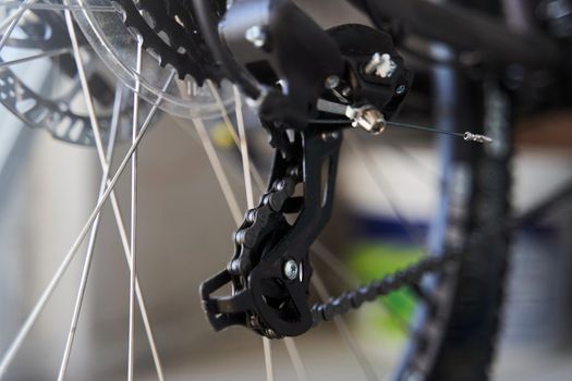 Mountain bike rear derailleur close-up. Rear racing bike cassette on the wheel with chain.