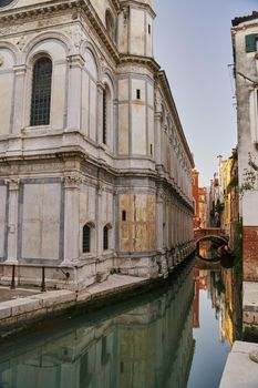 Venice, Italy - 10.12.2021: Traditional canal street with gondolas and boats in Venice, Italy. High quality photo