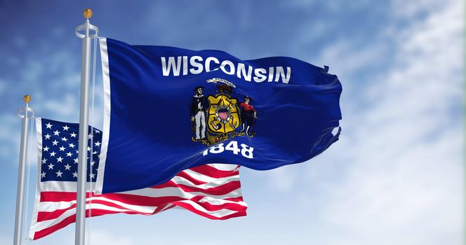 The Wisconsin state flag waving along with the national flag of the United States of America. Wisconsin is a state in the upper Midwestern United States