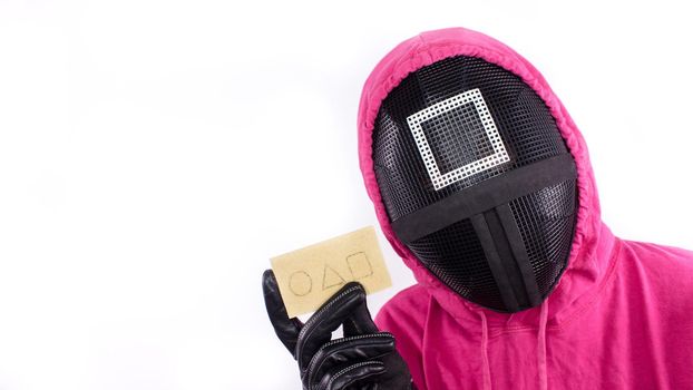 Pink Guard from Squid Game of new Netflix show. Squid Game red guard holds invitation card on white background. Space for text. South Korean tv series. Gatineau, Quebec Canada - November 2, 2021