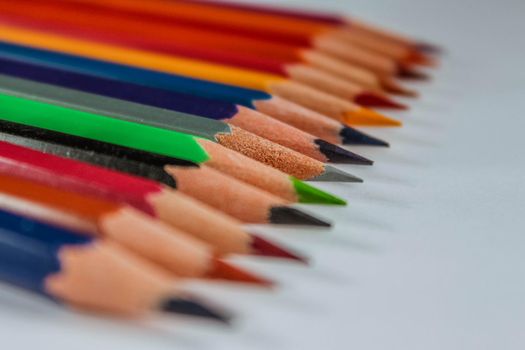 Row of multicolored wooden pencil collection isolated on white background