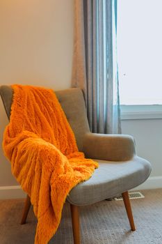 Giant orange Plaid Blanket Woolen Knitted on White Chair Home Scandinavian Style