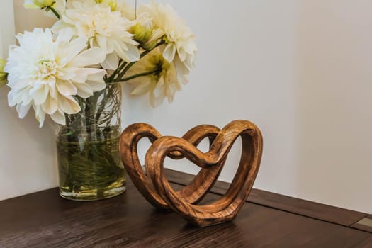 Two handmade wooden carved hearts on a table. Valentine day concept