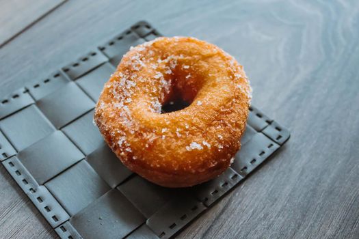 Sugar donut on a wooden background