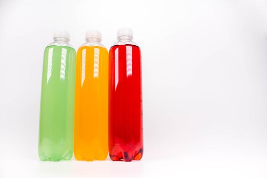 Energy drinks bottles with different flavors on a white background. Juice bottles