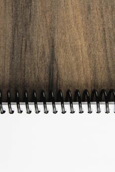 Spiral notepad paper on the wooden background. Vertical and space for text