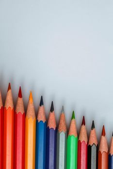 Row of multicolored wooden pencil collection isolated on white background