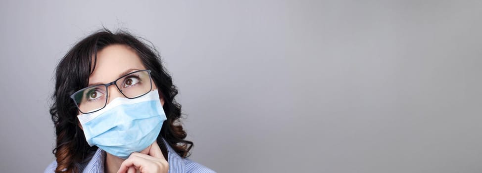 Woman wearing protection face mask against coronavirus. Woman in a mask and glasses. Medical mask, Close up shot, Select focus, Prevention from covid19
