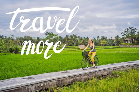 TRAVEL MORE concept A young woman rides a bicycle on a rice field in Ubud, Bali. Bali Travel Concept.