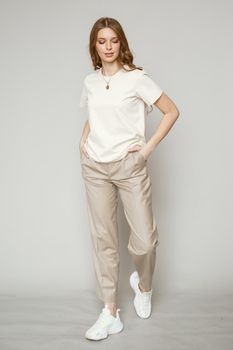 A model in brown casual clothes on a studio background.