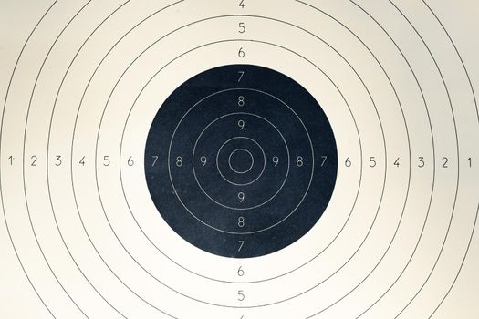 Blank paper target with shooting range numbers. A round, clean target with a marked bull's-eye for shooting practice on the range