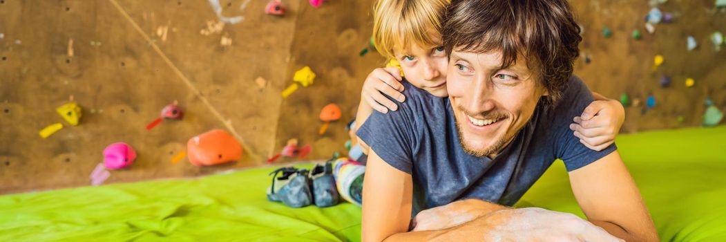 Dad and son at the climbing wall. Family sport, healthy lifestyle, happy family. BANNER, LONG FORMAT
