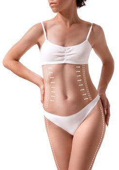 Female body with the drawing arrows on it isolated on white. Fat lose, liposuction and cellulite removal concept. Plastic surgery