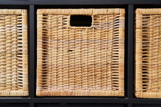 Wicker boxes for things on the shelves. Wardrobe for storage of things. High quality photo