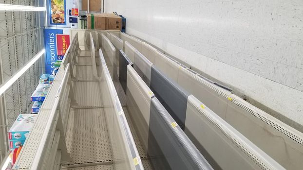 Empty Supermarket Shelves. Bare shelves and product shortages at grocery stores due to truck drivers strike