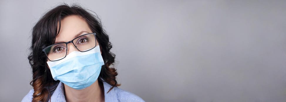 Woman wearing protection face mask against coronavirus. Woman in a mask and glasses. Medical mask, Close up shot, Select focus, Prevention from covid19