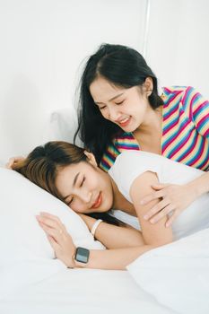 lgbtq, lgbt concept, homosexuality, portrait of two Asian women posing happy together and showing love for each other while being together at bedroom.