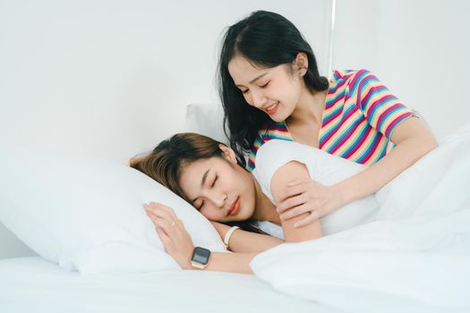 lgbtq, lgbt concept, homosexuality, portrait of two Asian women posing happy together and showing love for each other while being together at bedroom.