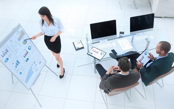 young business woman making a presentation to his business team in a modern office