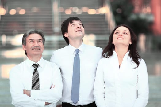 confident business team looking up at copy space.business concept