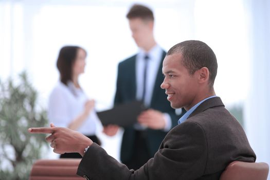 concept of purpose confident businessman pointing forward.photo blurred background.