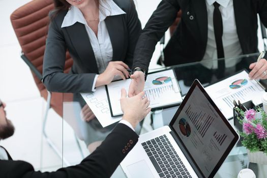close up.business partners stretching their hands for a handshake .concept of partnership