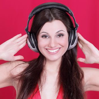young woman listening to music through headphones .
