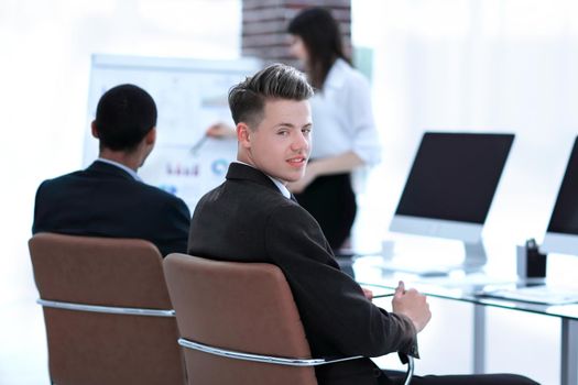 employee of the company on the background of business team in a modern office