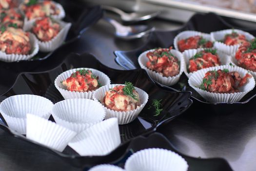 close up.meat muffins in forms on the table.