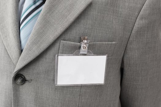 White blank name tag is attached to chest in the businessman .