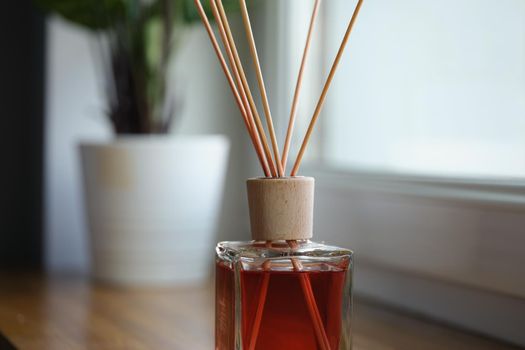 Incense sticks on the windowsill, close-up, blurry. Home fragrances, aroma diffuser. A mixture with a pleasant smell