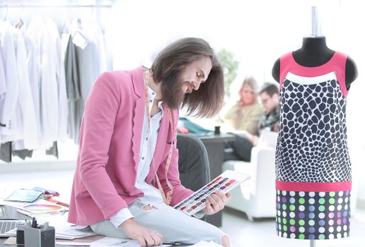 portrait of a fashionable tailor in a modern Studio.