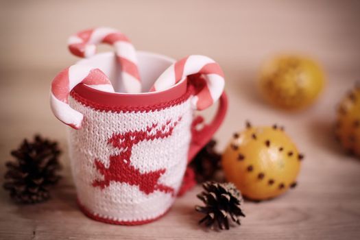 Christmas Cup and oranges on wooden background blurred.photo with copy space