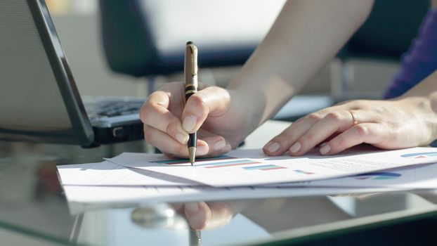 close up. business woman plans financial expenses of the company.