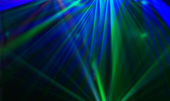 Disco. Laser show. Laser beams at the disco in the blur