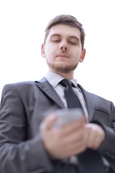 close up.serious businessman reading text message on smartphone.